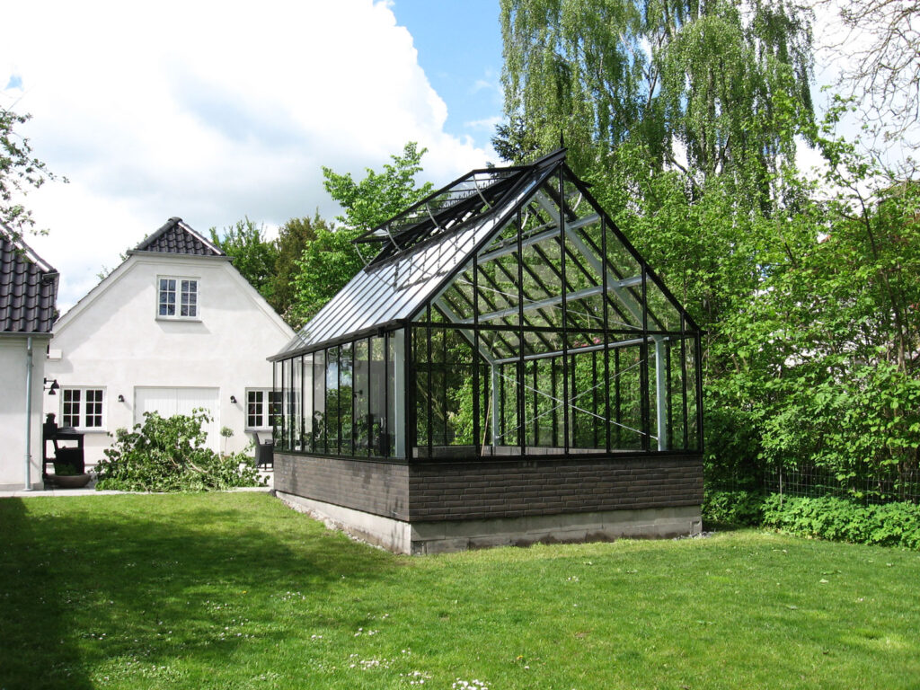 Free-standing greenhouse in domestic garden